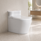 A white wall-mounted smart toilet with a closed lid, shown installed against a beige plaster wall in a modern bathroom with a wood vanity and sink in the background.