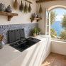 NIX38 gun grey workstation sink installed under a window with folding covers open